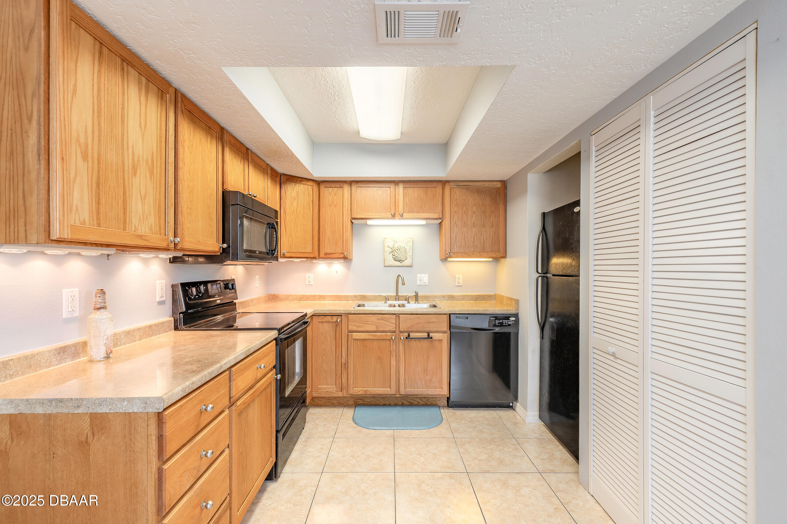 601 Sea Gull Court Edgewater, FL 32141 - Photo 9 of 25 a kitchen with stainless steel appliances granite countertop a sink and cabinets