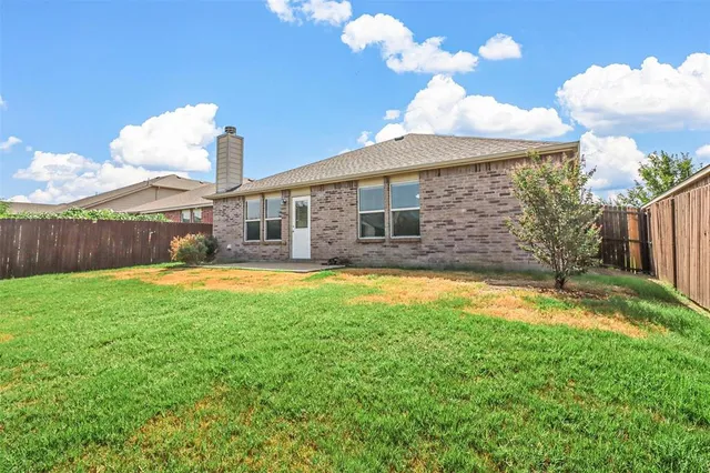 a view of a house with swimming pool and a yard