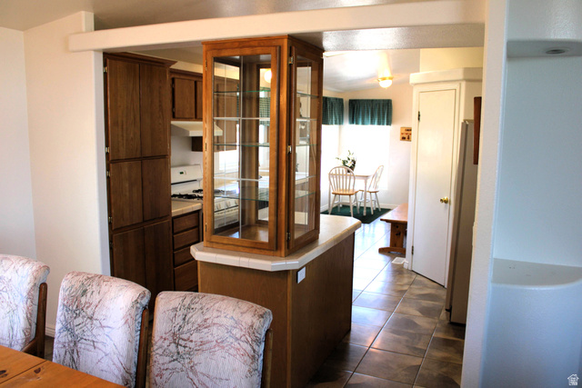22580 Spring Creek Drive, Unit B61 Fairview, UT 84629 - Photo 15 of 39 Kitchen area featuring wood-finish cabinetry, a built-in display cabinet, and a functional counter space