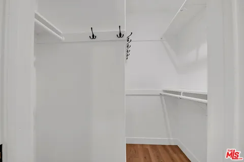 a view of walk in closet with empty racks