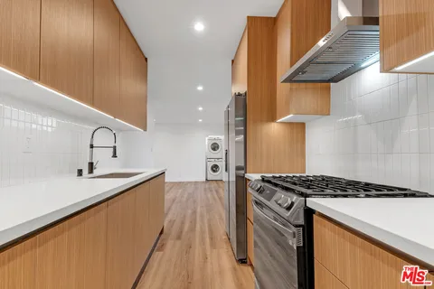a kitchen that has a sink and a stove