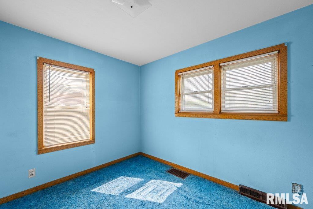 4234 9th Street Rock Island, IL 61201 - Photo 11 of 22 a view of an empty room with a window and wooden floor