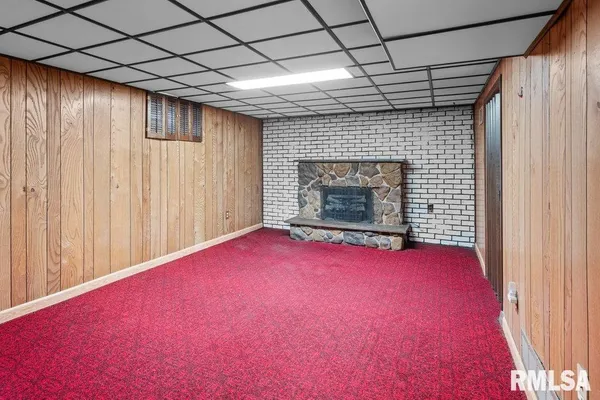 a view of empty room with wooden floor and fireplace