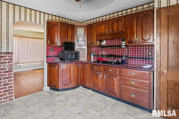 a kitchen with stainless steel appliances granite countertop a refrigerator and cabinets