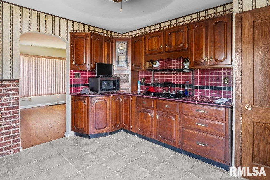 4234 9th Street Rock Island, IL 61201 - Photo 4 of 22 a kitchen with stainless steel appliances granite countertop a refrigerator and cabinets