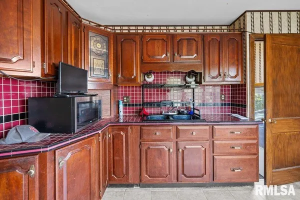 a kitchen with stainless steel appliances granite countertop a refrigerator and microwave