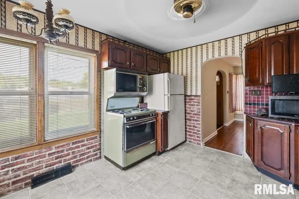 a kitchen with stainless steel appliances granite countertop a stove a refrigerator and a sink