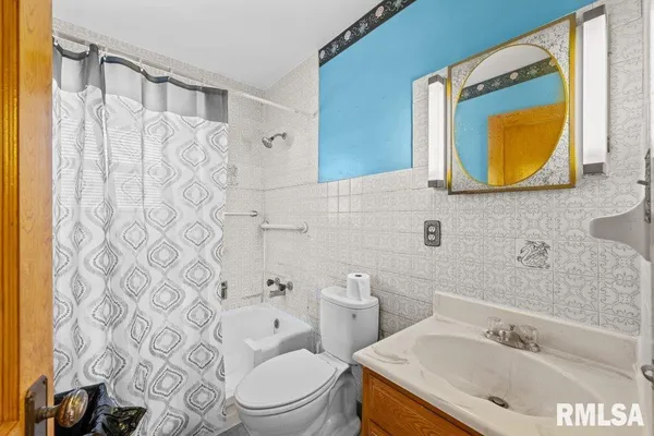 a bathroom with a sink mirror vanity and toilet