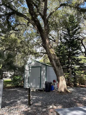 a view of a yard with table and chairs and a fire pit