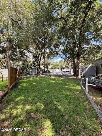 a view of a park with bench and trees