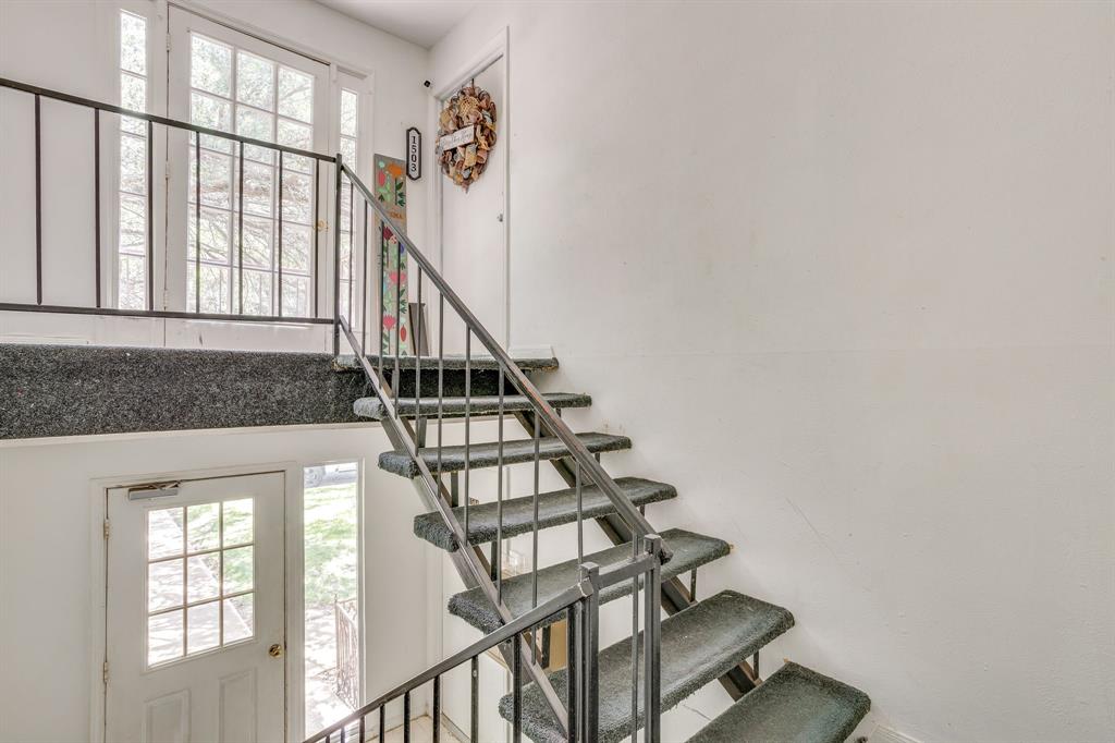 4102 Ridglea Country Club Drive, Unit 1503 Fort Worth, TX 76126 - Photo 15 of 21 Multi-level interior featuring a carpeted staircase with metal railings, white walls, and glass-paned doors providing natural light