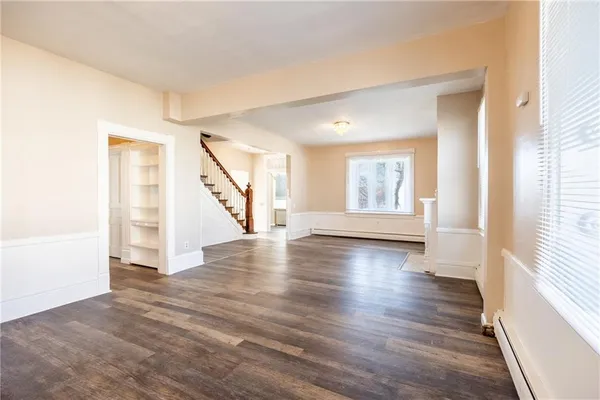 a view of an entryway with wooden floor