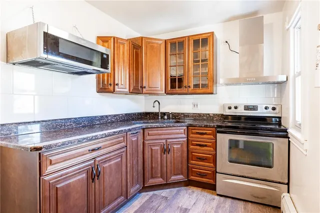 a kitchen with stainless steel appliances granite countertop a stove and a sink