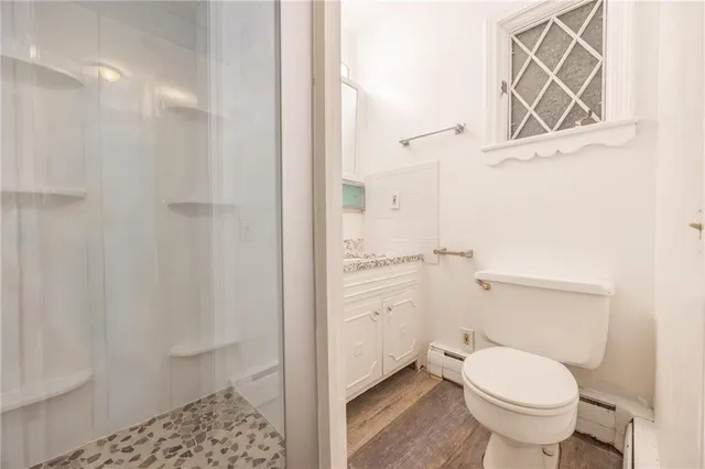 a bathroom with a granite countertop toilet a sink and a mirror