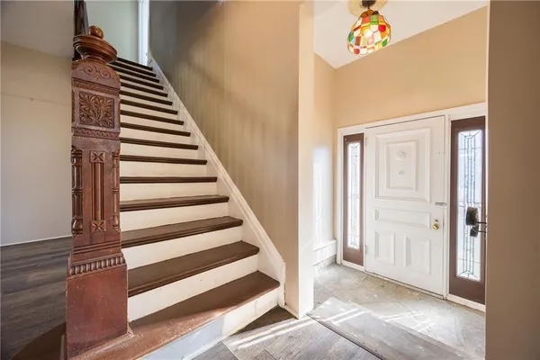 a view of entryway and hall with wooden floor