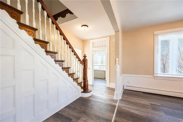 a view of an entryway with wooden floor