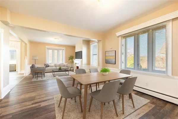 a view of a dining room with furniture and wooden floor