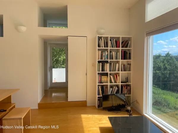 a view of a workspace with furniture and a window