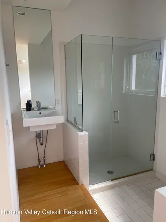 a bathroom with a sink a mirror and a shower