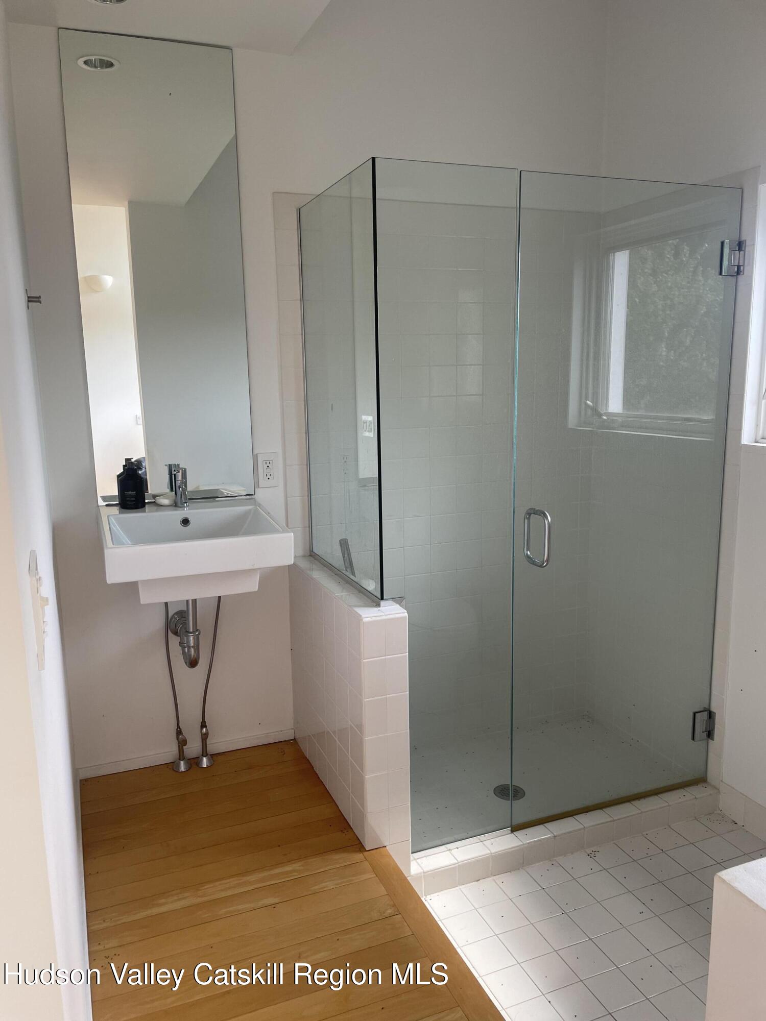 156 Mercer Mountain Road Canaan, NY 12060 - Photo 16 of 28 a bathroom with a sink a mirror and a shower