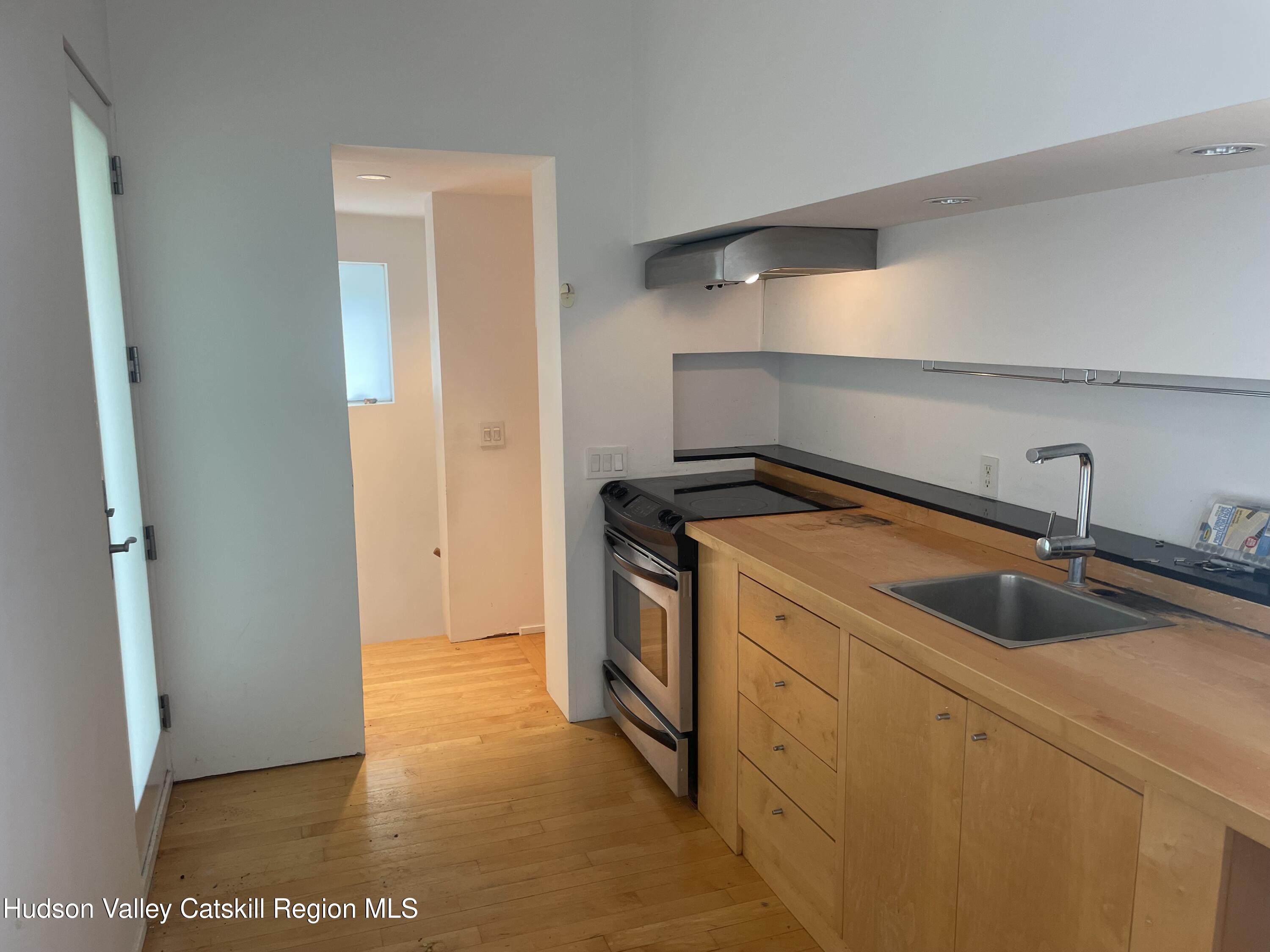 156 Mercer Mountain Road Canaan, NY 12060 - Photo 7 of 28 a kitchen with a sink and a refrigerator
