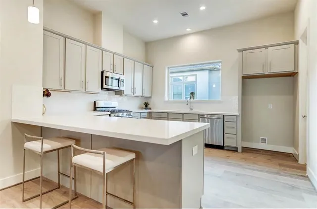 a kitchen with a sink cabinets and window