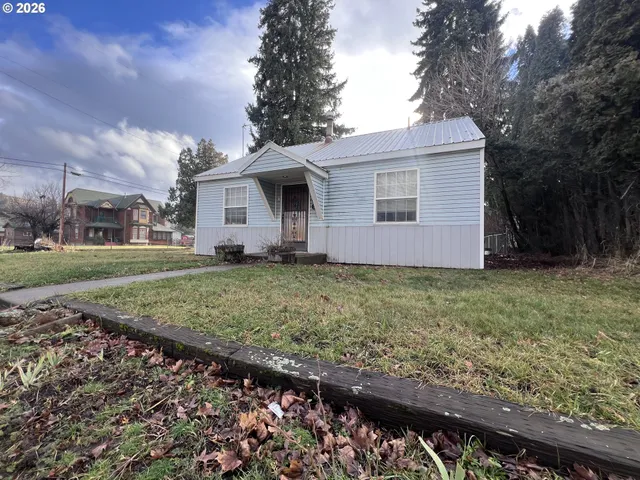a front view of house with yard and trees