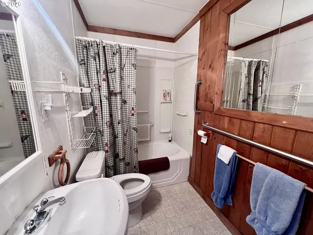 a bathroom with a toilet a sink and a shower