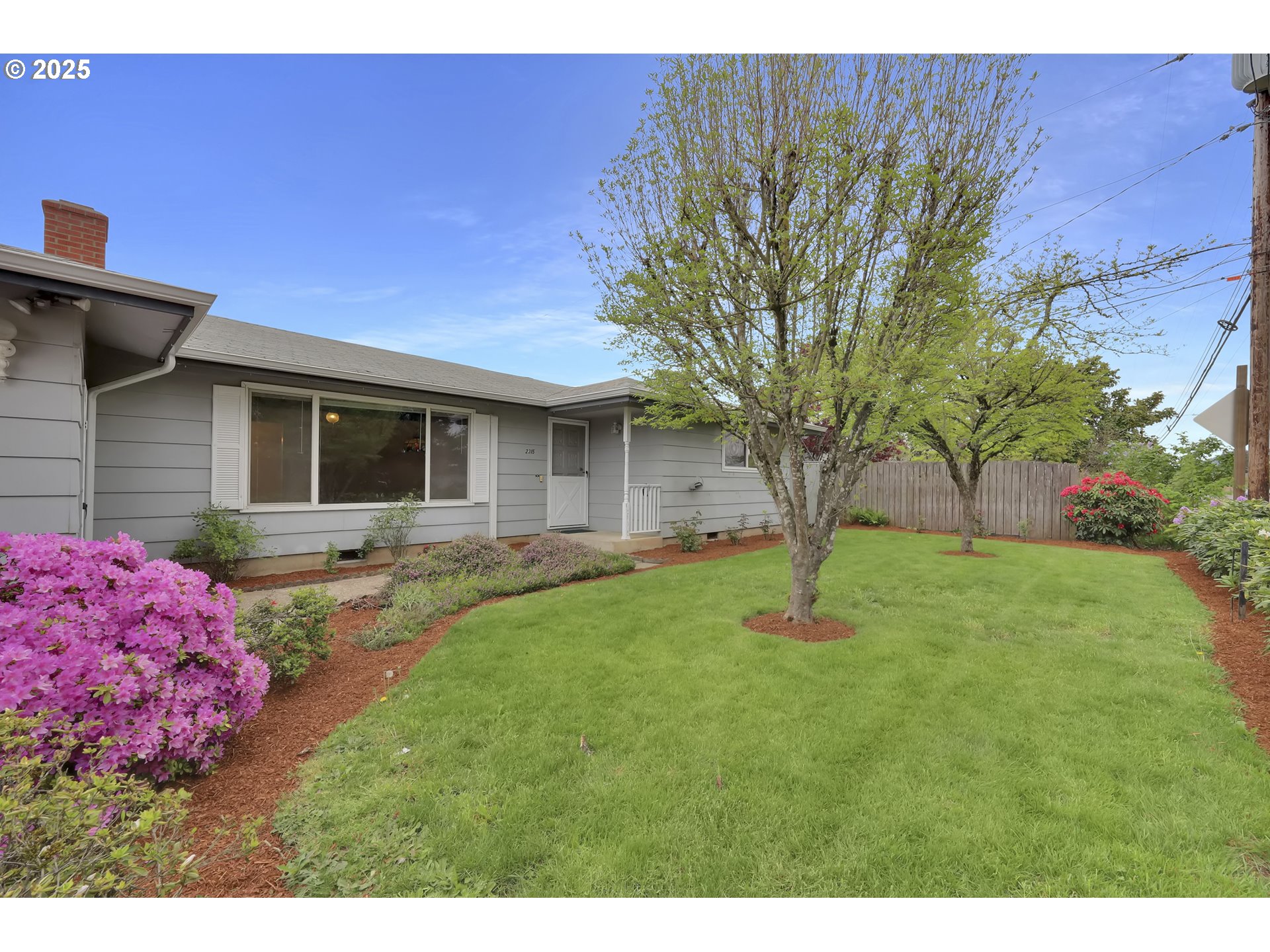 2315 19th Street Springfield, OR 97477 - Photo 1 of 30 a backyard of a house with table and chairs