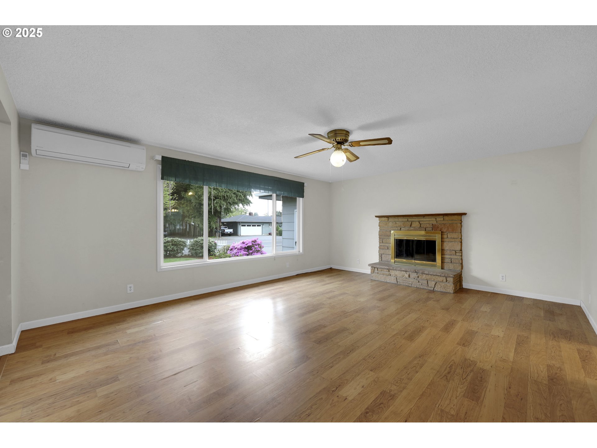 2315 19th Street Springfield, OR 97477 - Photo 5 of 30 a view of an empty room with a window and fireplace