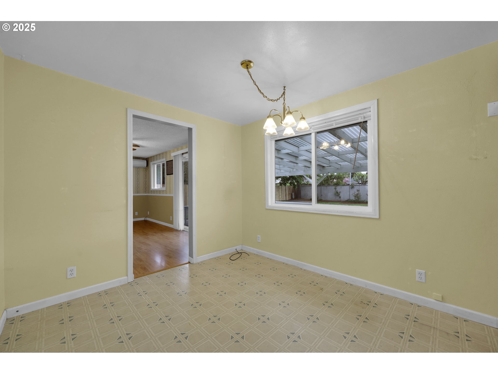 2315 19th Street Springfield, OR 97477 - Photo 6 of 30 close view of an empty room with window and wooden floor
