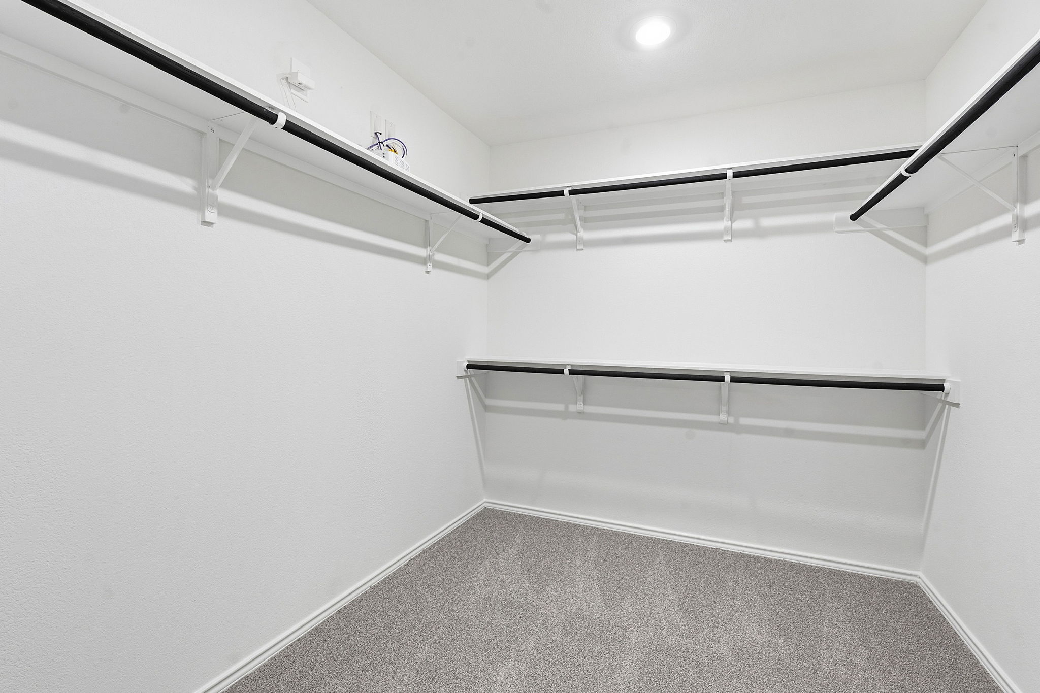 164 Cinnabar Lane, Unit 5 Kyle, TX 78640 - Photo 14 of 21 Built-in closet organization system featuring white shelving and black hanging rods