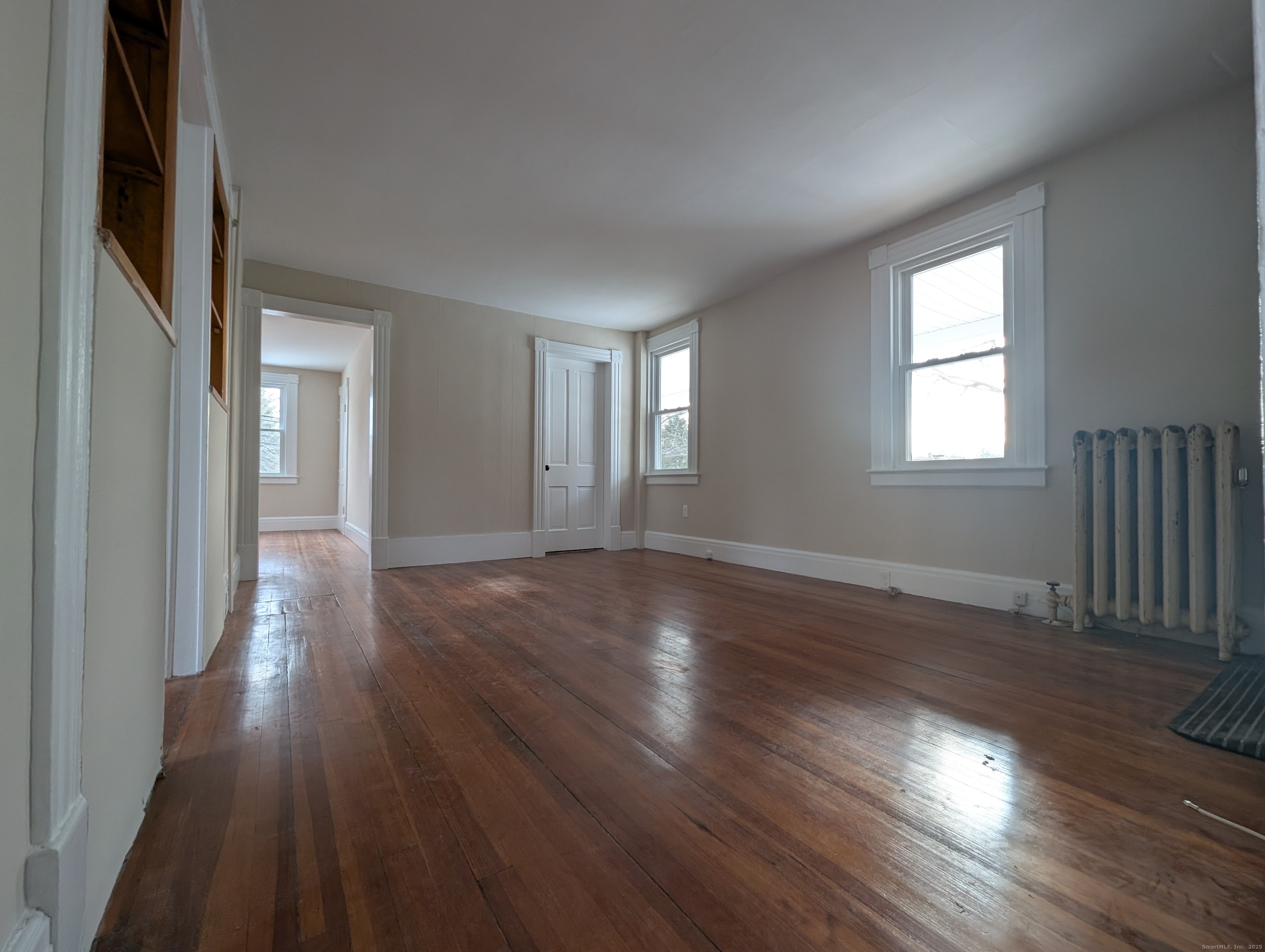 86 Main Street, Unit A East Windsor, CT 06016 - Photo 1 of 11 an empty room with wooden floor and windows