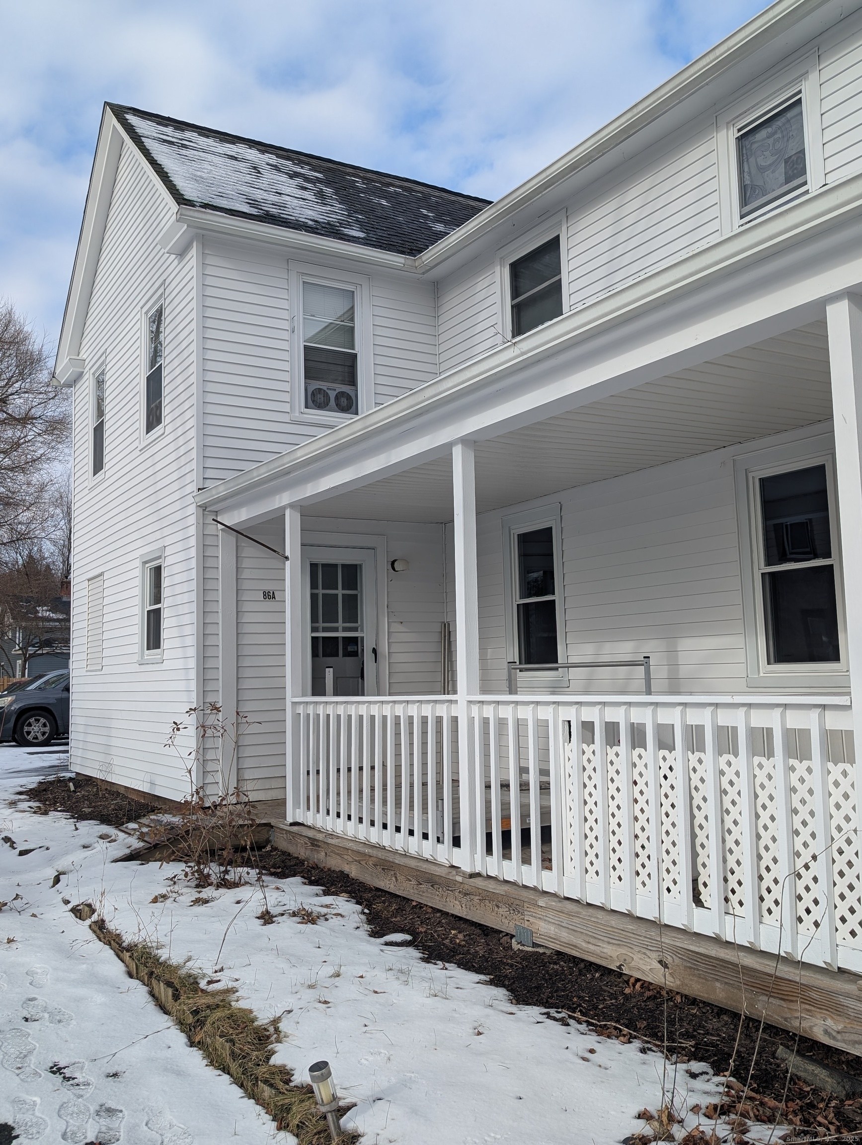 86 Main Street, Unit A East Windsor, CT 06016 - Photo 1 of 17 front view of a house with wooden fence