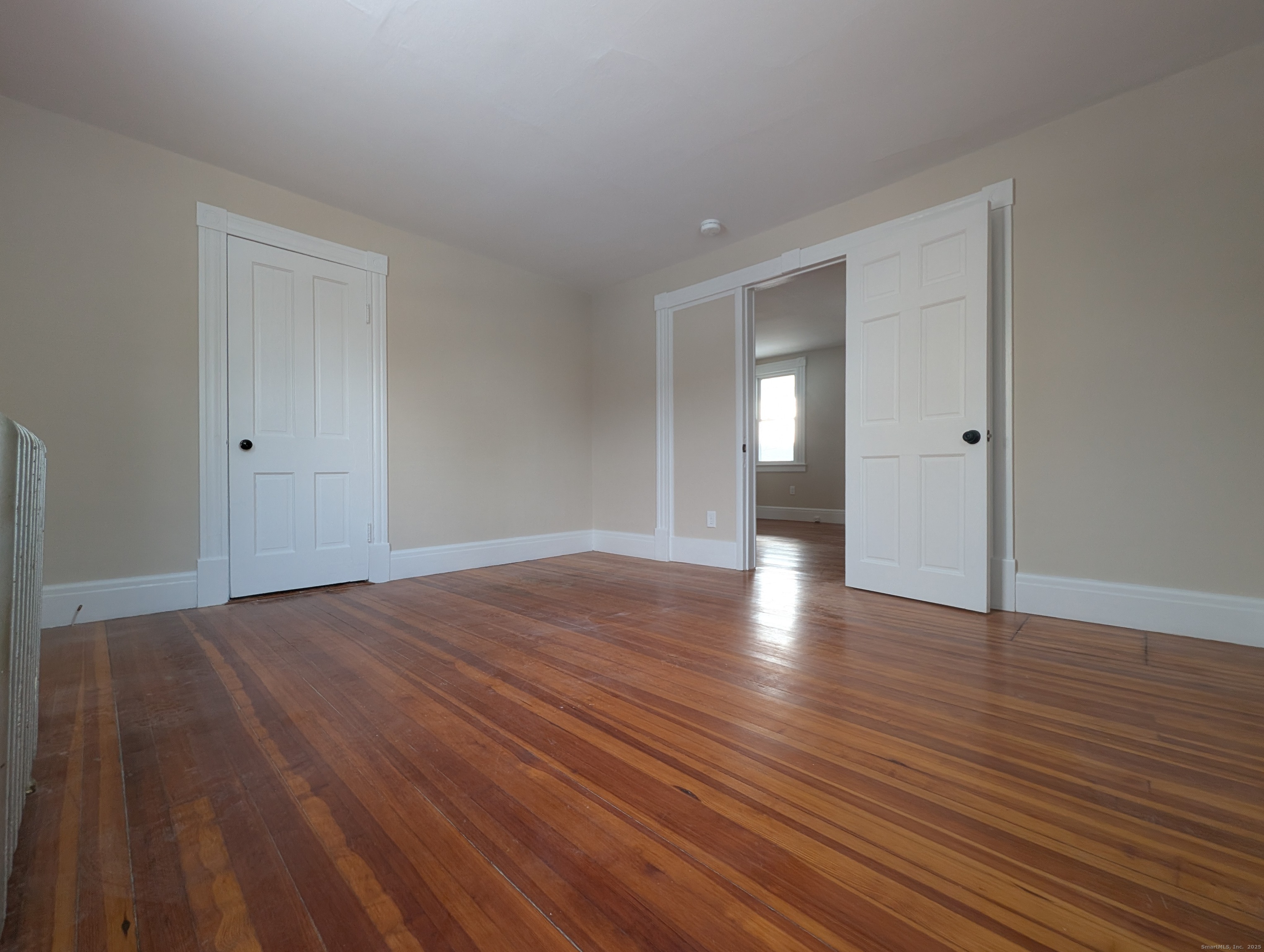 86 Main Street, Unit A East Windsor, CT 06016 - Photo 11 of 17 a view of empty room with wooden floor and fan