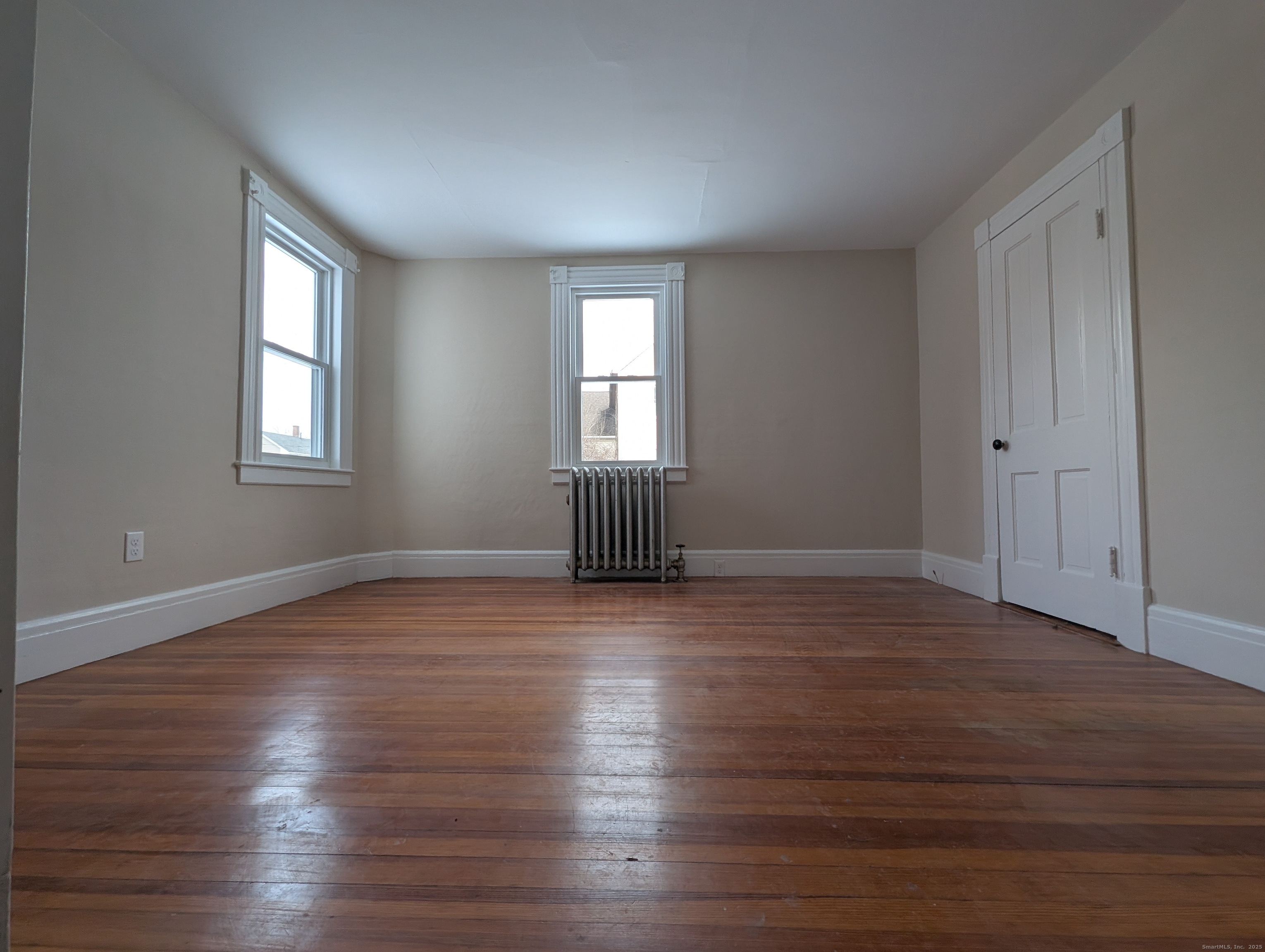 86 Main Street, Unit A East Windsor, CT 06016 - Photo 12 of 17 a view of empty room with wooden floor and fan