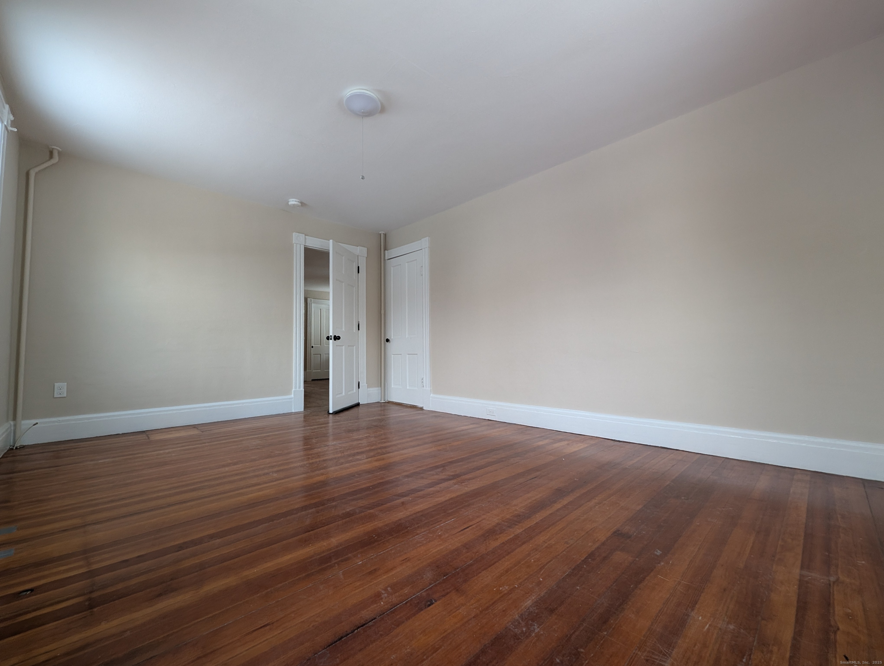 86 Main Street, Unit A East Windsor, CT 06016 - Photo 8 of 17 a view of an empty room with wooden floor and closet