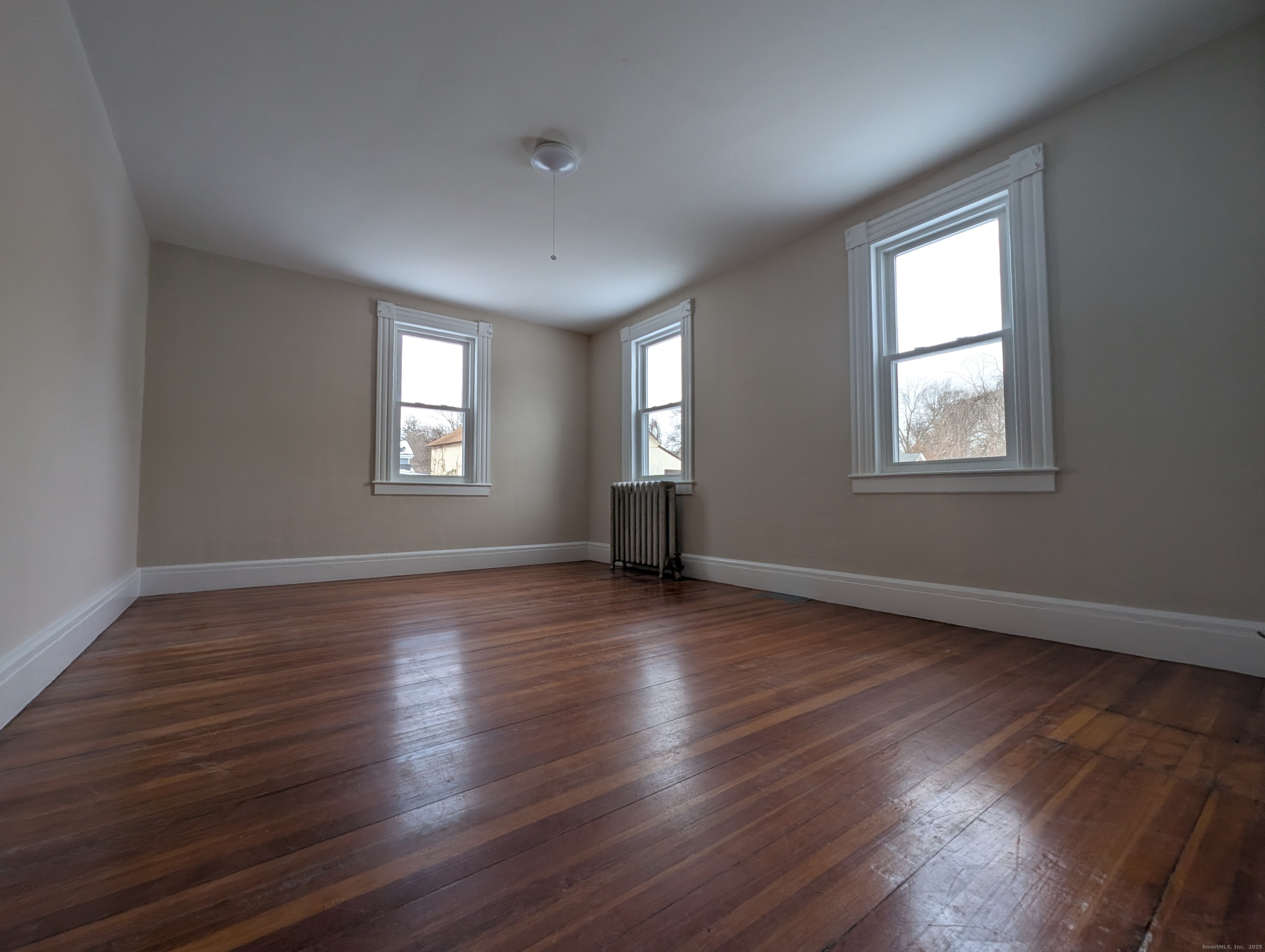 86 Main Street, Unit A East Windsor, CT 06016 - Photo 9 of 17 an empty room with wooden floor and windows