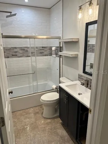 a bathroom with a toilet a sink and a mirror