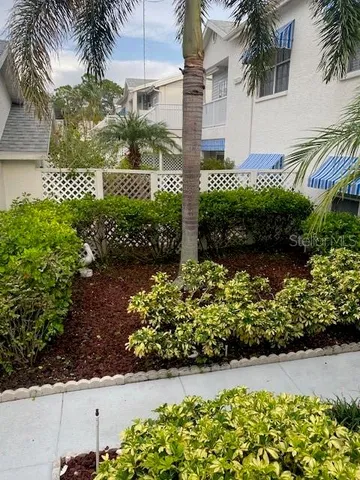 a front view of a house with a yard and flowers
