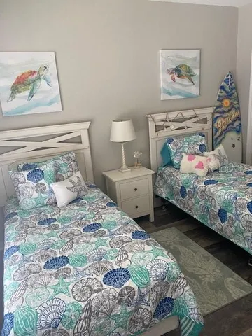 a bedroom with a bed and a painting on the wall