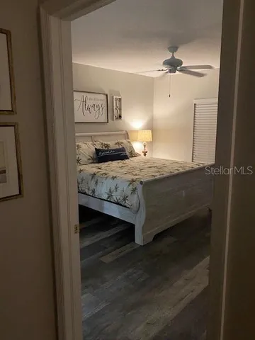 a bedroom with a bed and wooden floor