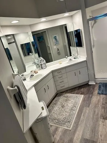 a bathroom with a double vanity sink and mirror