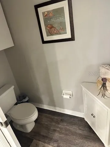 a white toilet sitting next to a bathroom sink