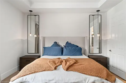 a large bedroom with a bed and a chandelier