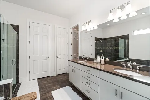 a bathroom with double sink and a mirror