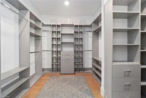 a view of walk in closet with empty racks