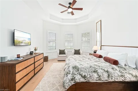 a bedroom with a bed and dresser with mirror