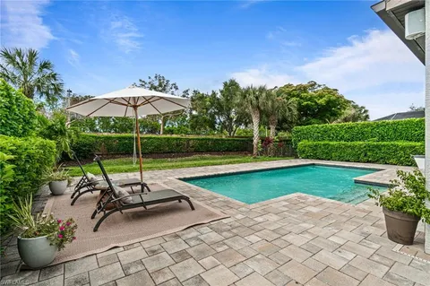 a view of a backyard with sitting area and furniture