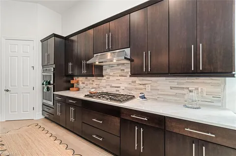 a kitchen with stainless steel appliances wooden cabinets and a sink